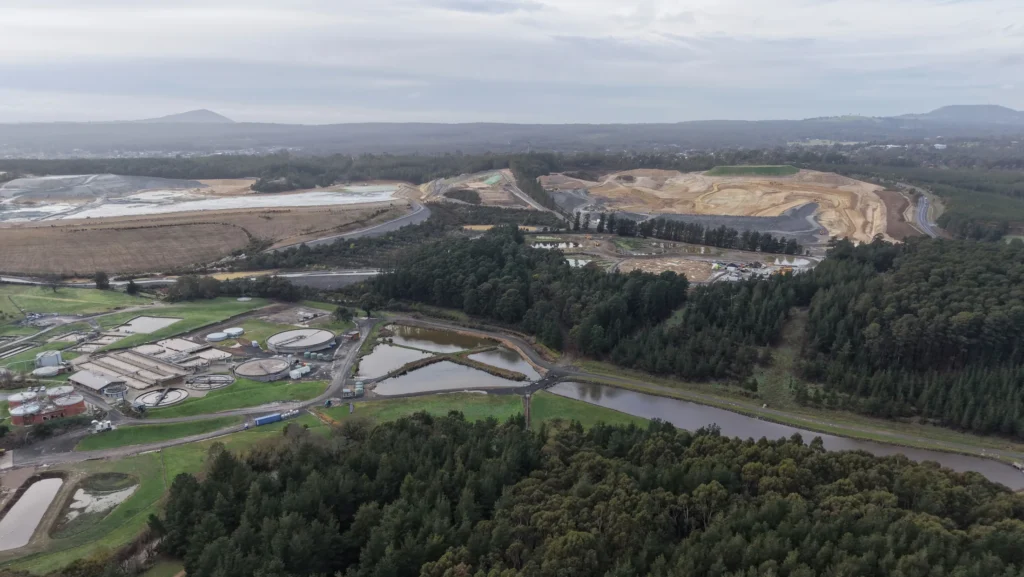 Aerial view of a treatment works, woodland and surrounding land development.